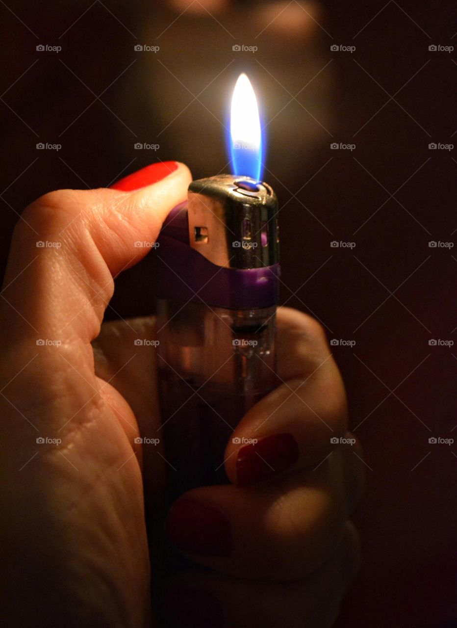 burning fire in the female hand night photography