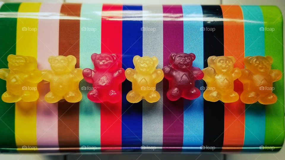 Gummies Holding Hands in a Rainbow Tin