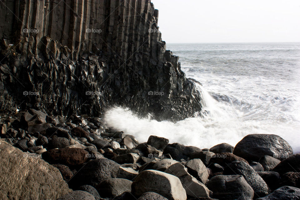 Basalt rock formations and sea