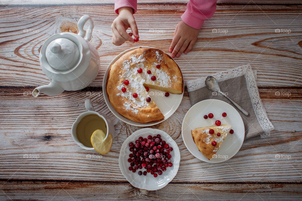 Children breakfast with cheesecake. Hands, detail