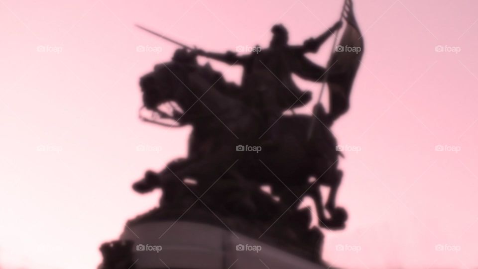 red gradient sky and scenic active statue silhouette