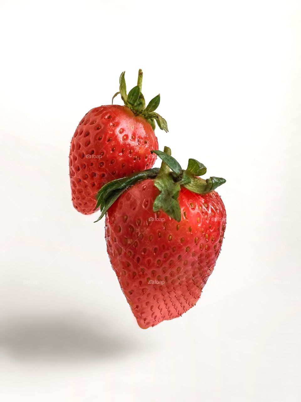 Red flying strawberry on white background 