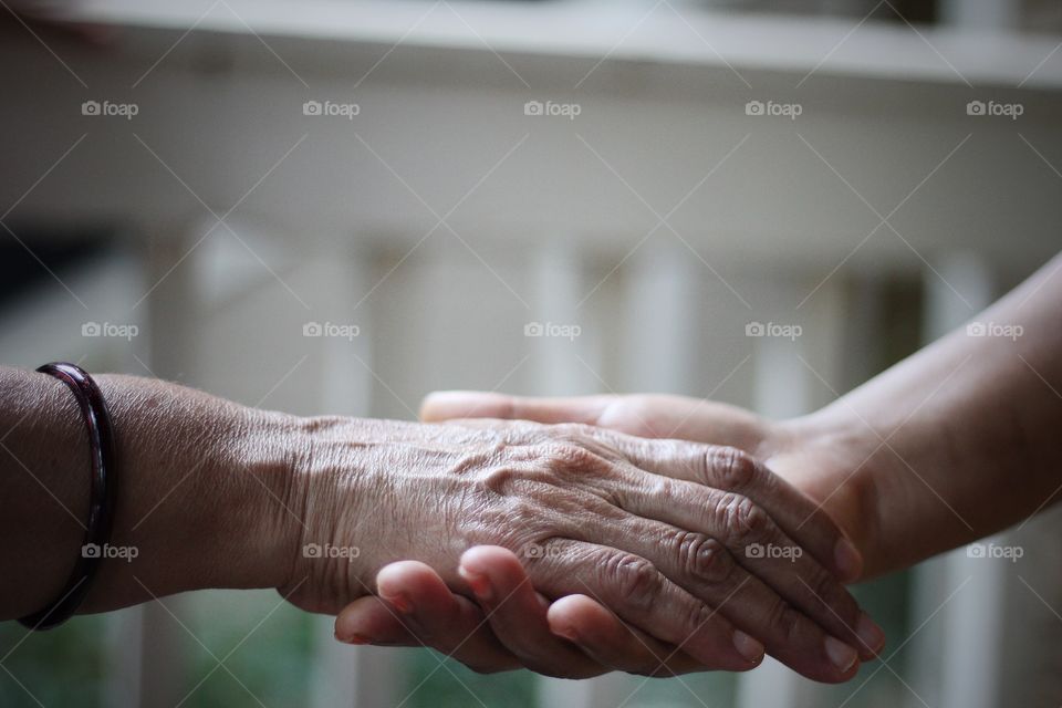 Supporting old age woman at seniors home for medical check up 