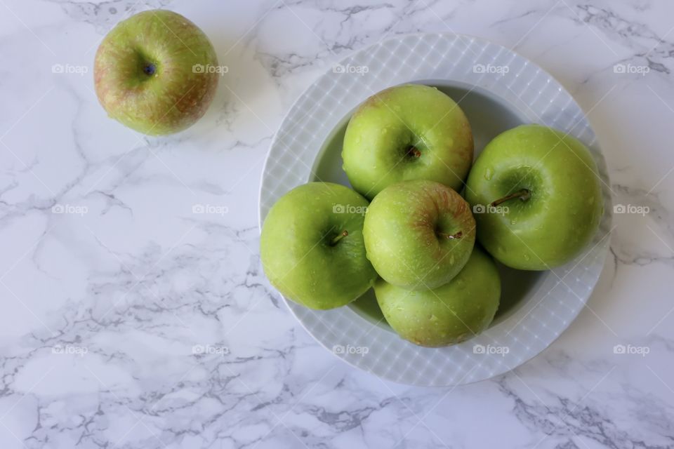 Green apples on the white background 