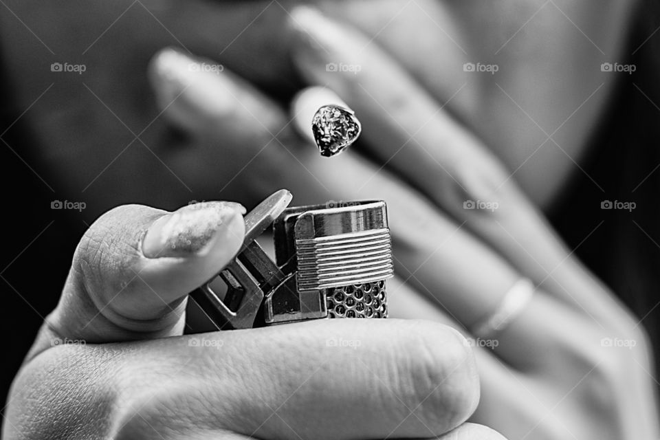 Close-up of person lighting cigarette