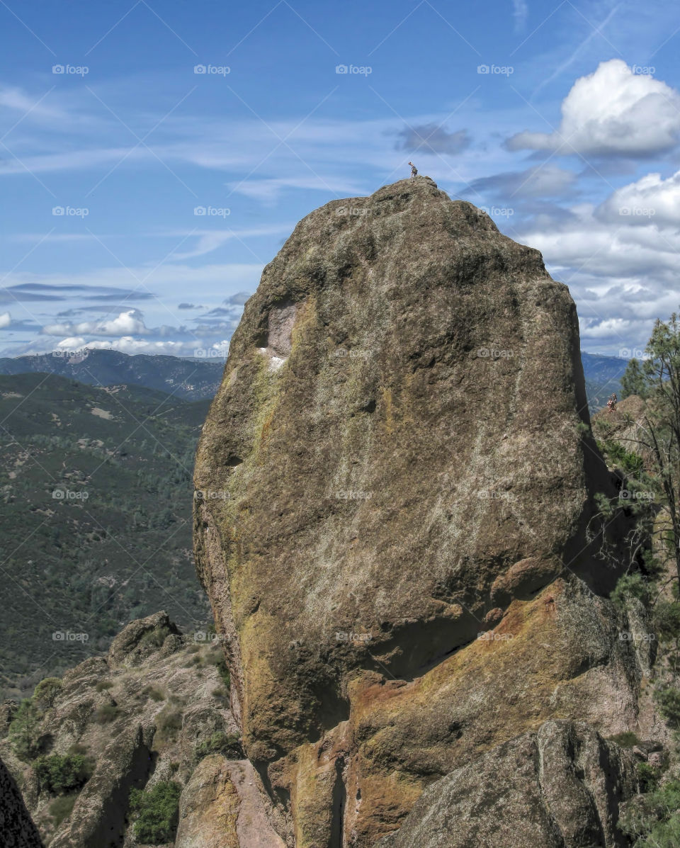 Climber on top of massive boulder