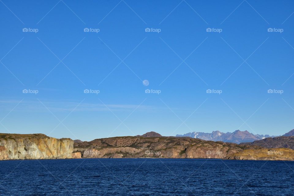 general carrera lake with the moon in the background in chilean patagonia