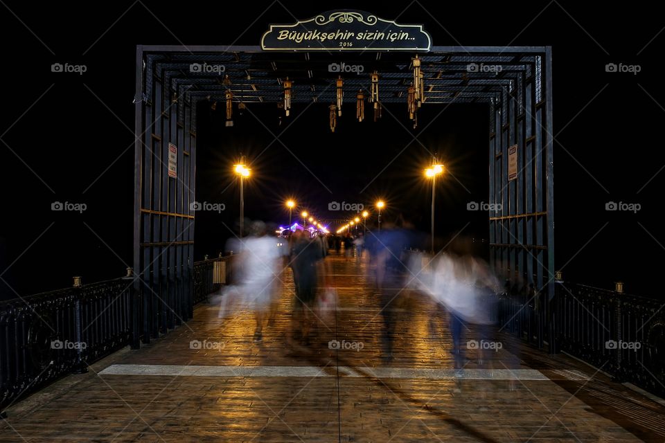 People are walking on jetty at black sea night