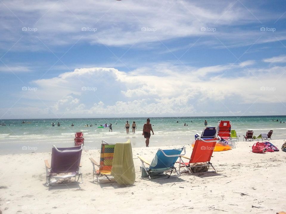 Beach chairs and swimmers