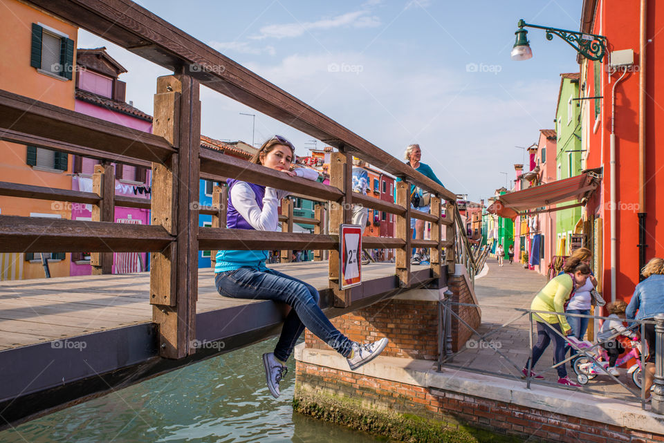 Woman on bridge over canal in the city