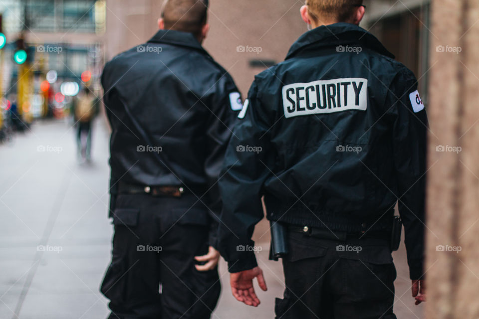 Security walking down the streets of downtown Minneapolis.