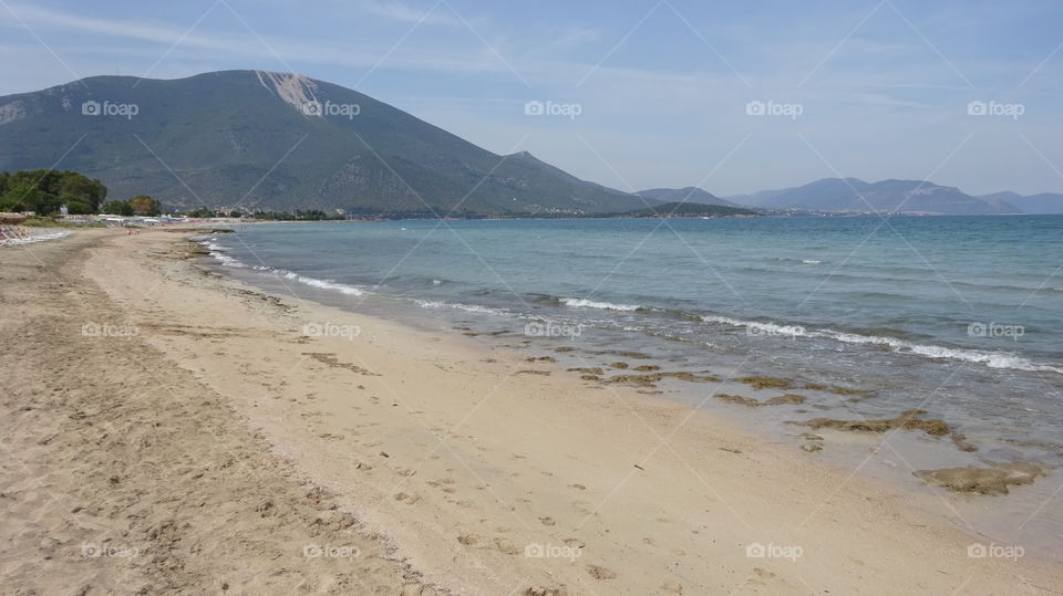 View of a sea and mountains against sky