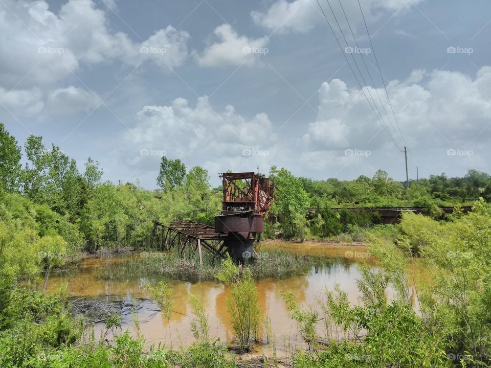 pond with old rusty metal structure