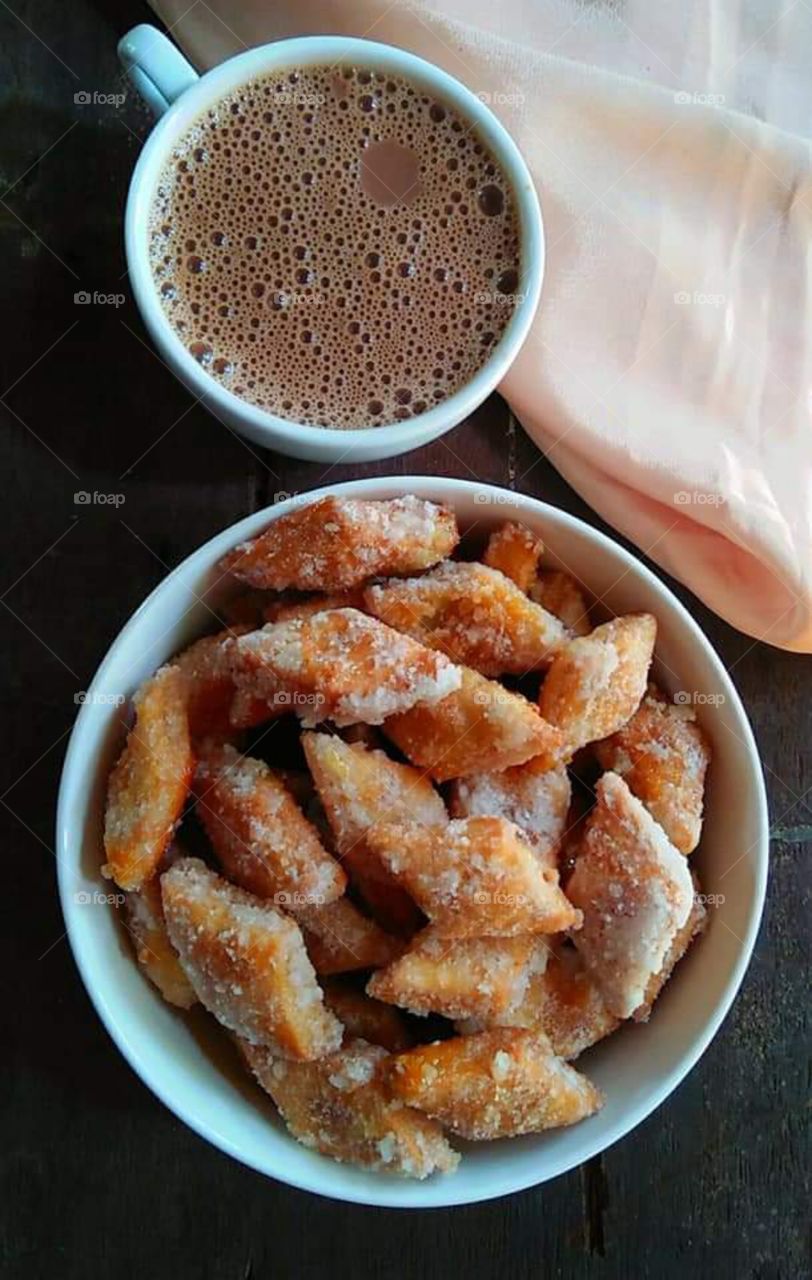 delicious Indian sweet snack with a cup of hot chocolate coffee drink .