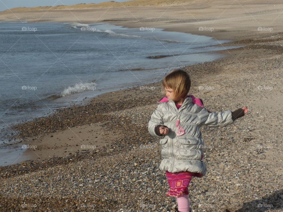 Girl playing on the beach