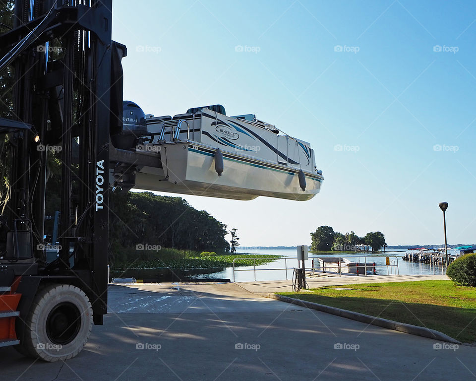 Toyota forklift moving boat from point A to point B