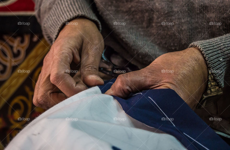 Close-up of man's hands sewing