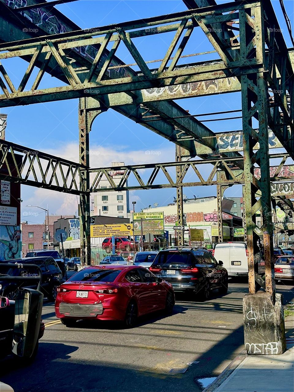 This is the early industrial age overpass on “Myrtle Ave” in “Bushwick”, Brooklyn with its intricate multifaceted structures that cast elaborate shadows onto the street and sidewalks. 2024. Hypnotic Productions