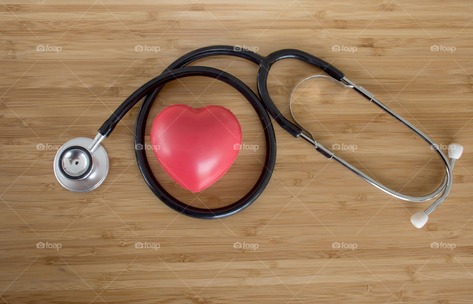 Close up Red heart and a stethoscope on wooden table, World health day campaign Concepts