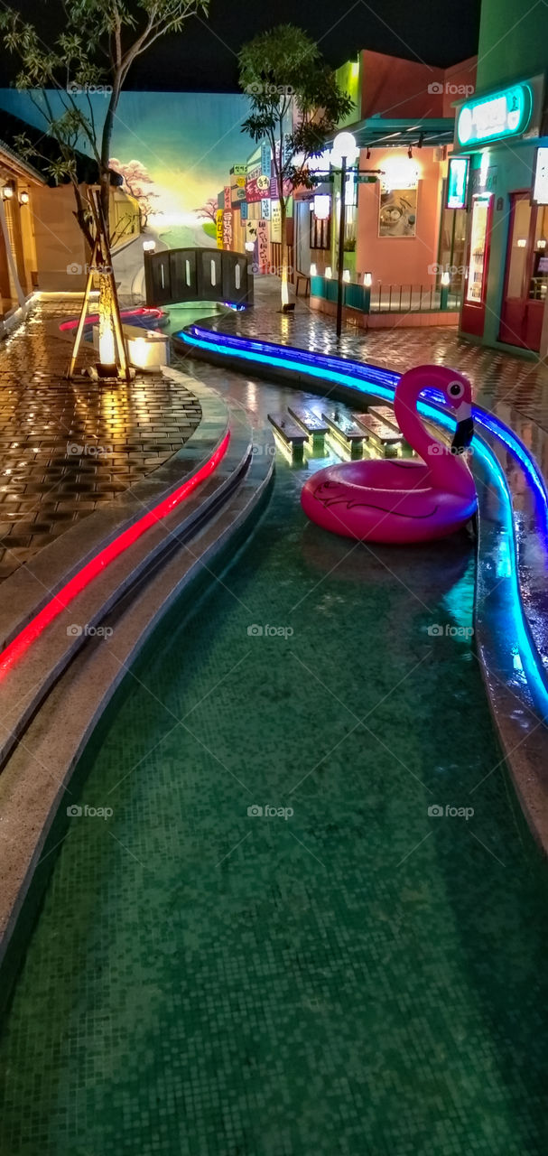 Balloon swans are swimming in the summer pool