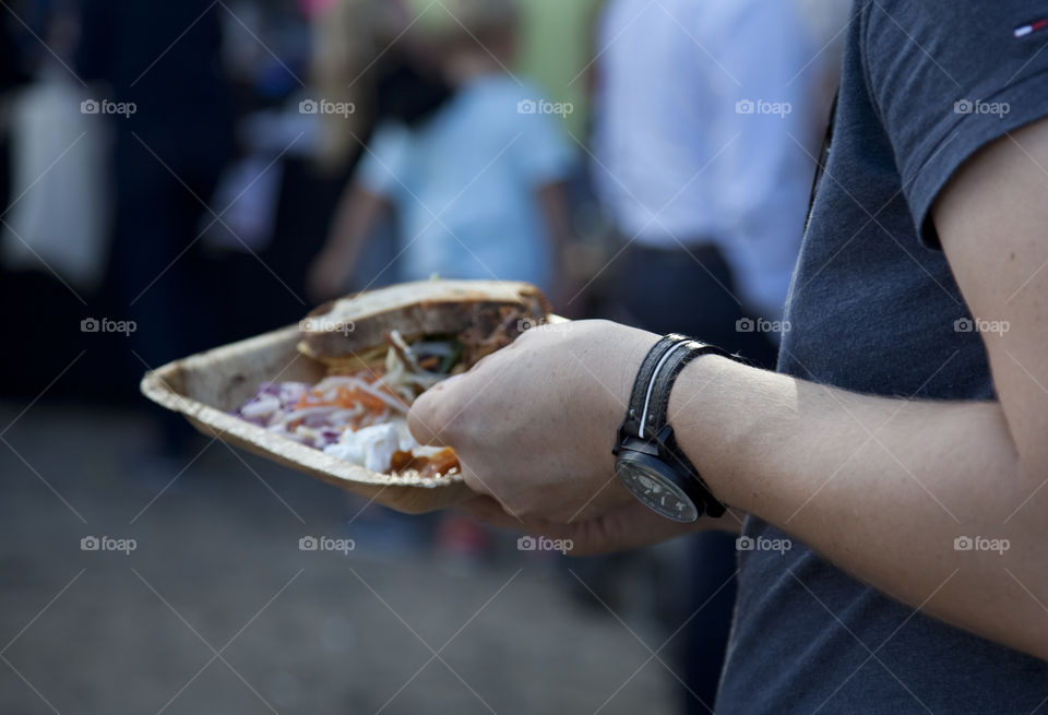 Close-up of men holding street food