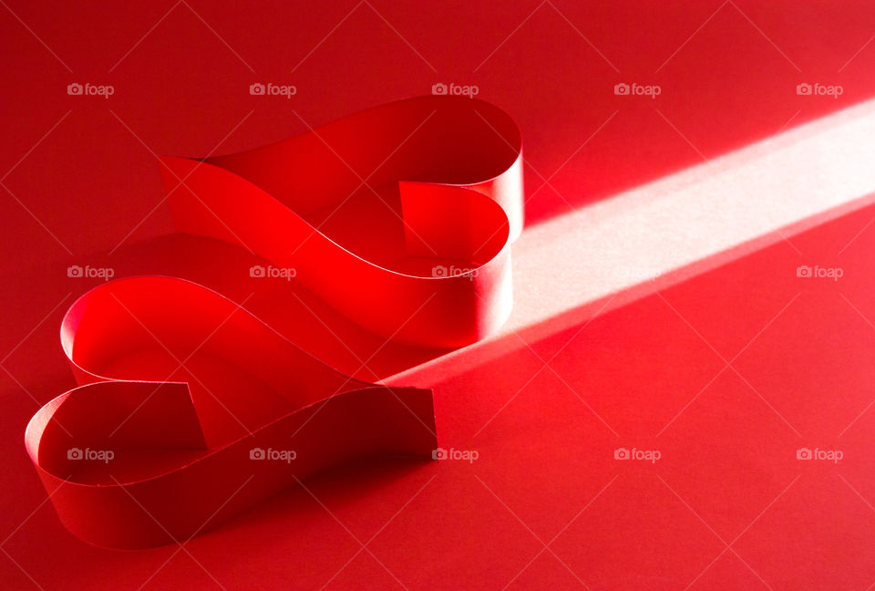 Hearts on red background with sunrise 