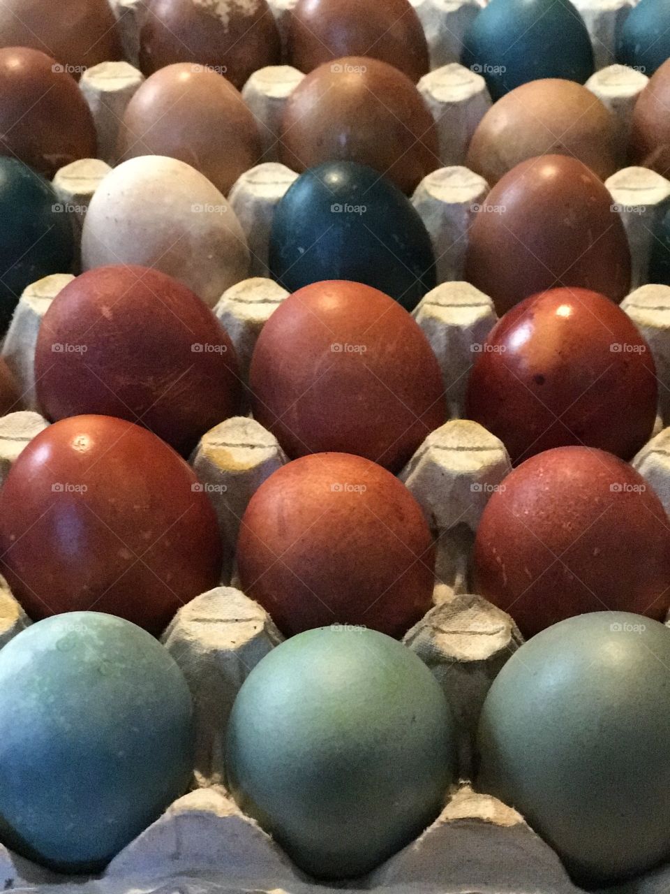 Many eggs painted at home with vegetables colors for Easter tradition