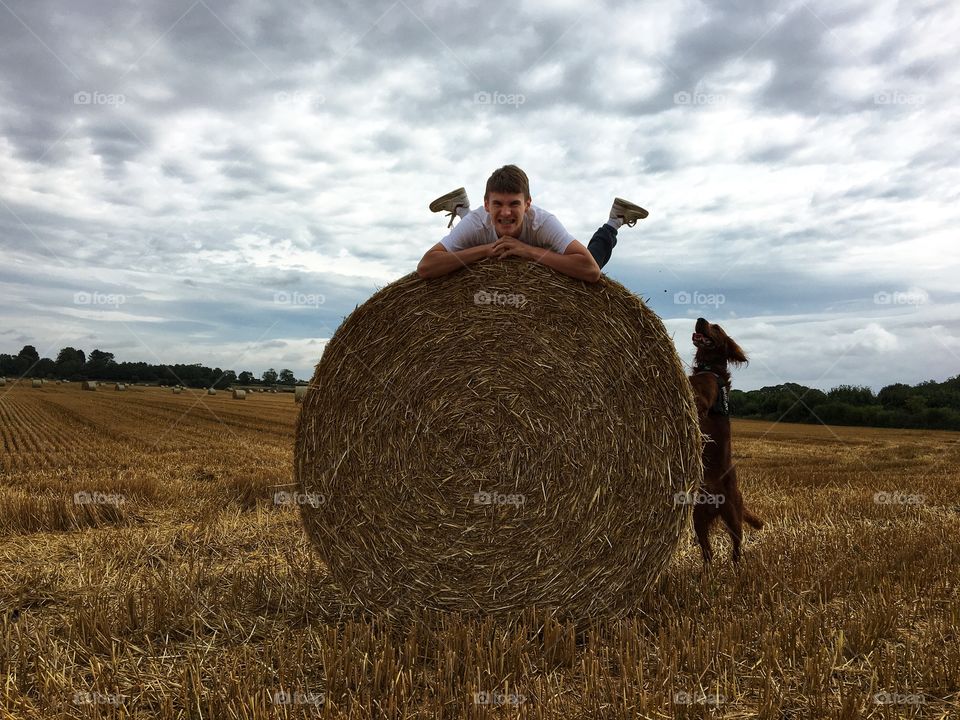 Having fun in a farmers field ... climbing onto a hay bale and the dog trying to clamber up too !