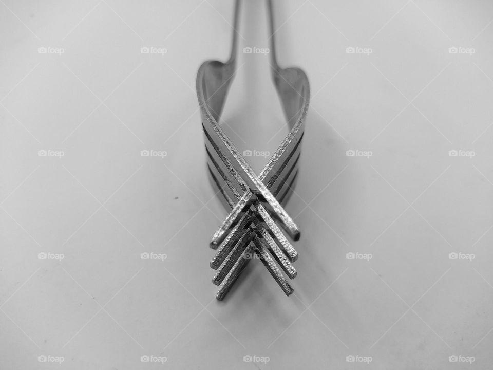 Two forks joined together, isolated on white background