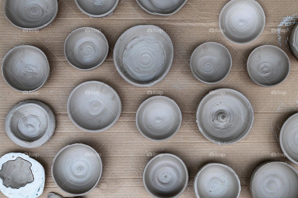 Air drying clay round bowls.