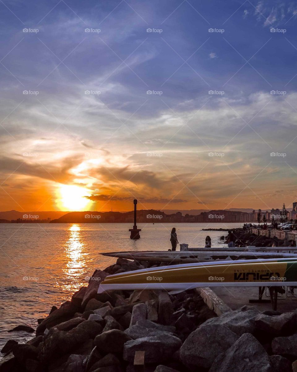 Beautiful Brazilian seashore, with boats at the sunset.
Beautiful orange and blue seascape.