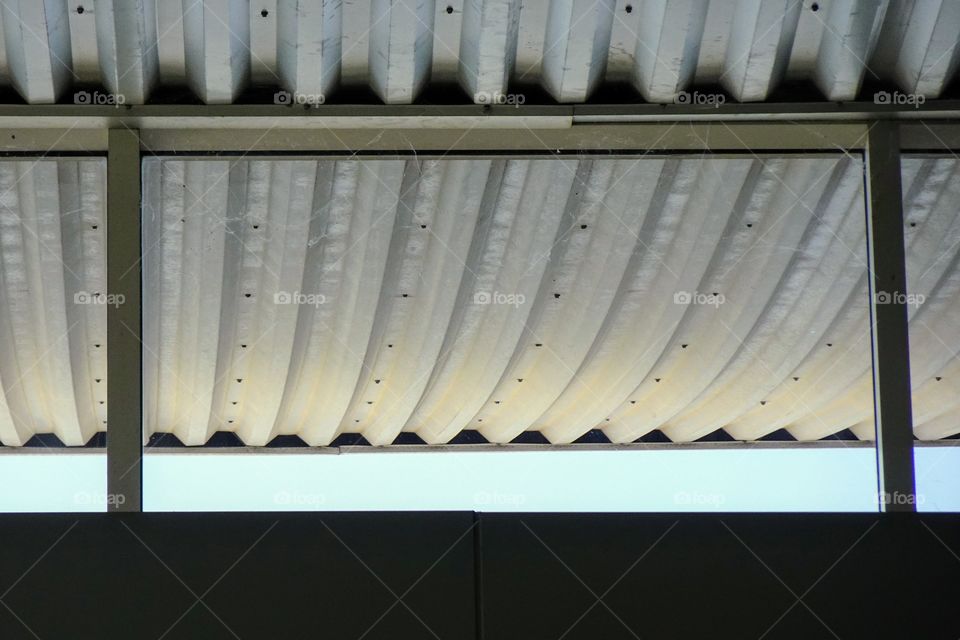 The roof cuts against the sky and the building