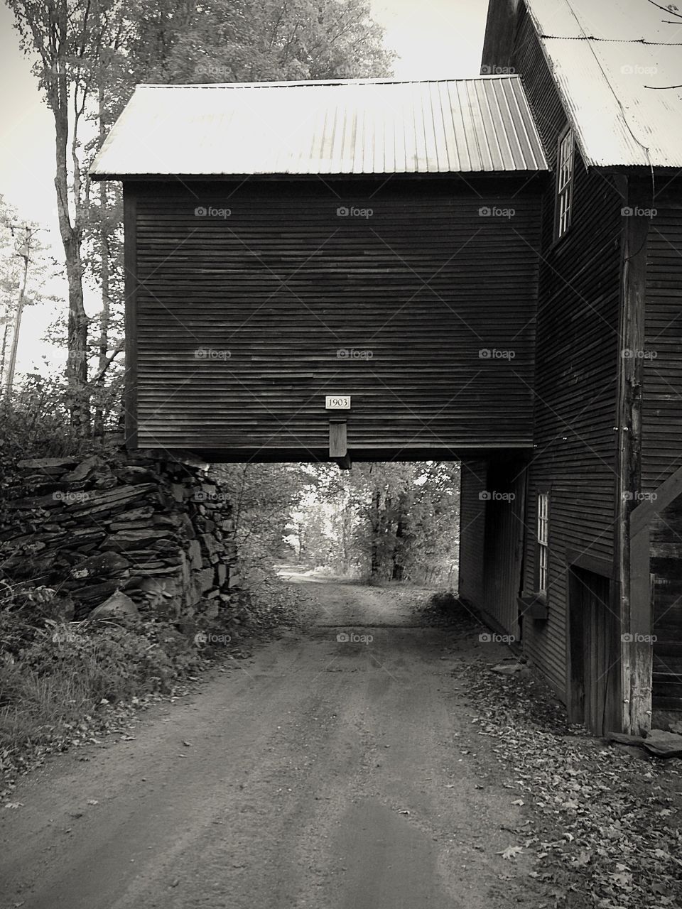 1903. Drive under the barn - black and white architecture mission 

