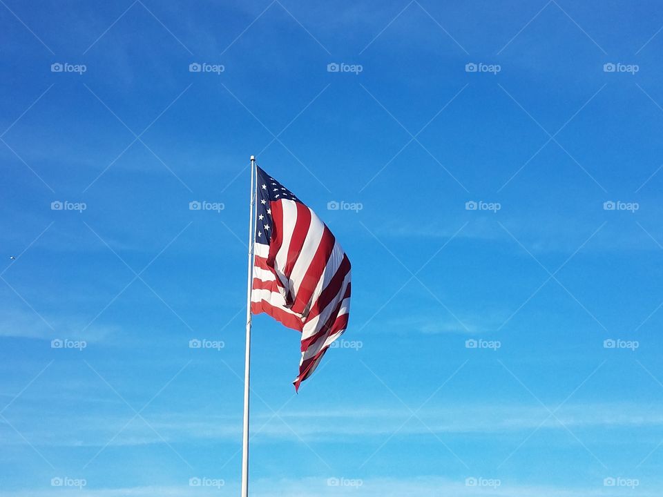 The American flag wavers in the wind