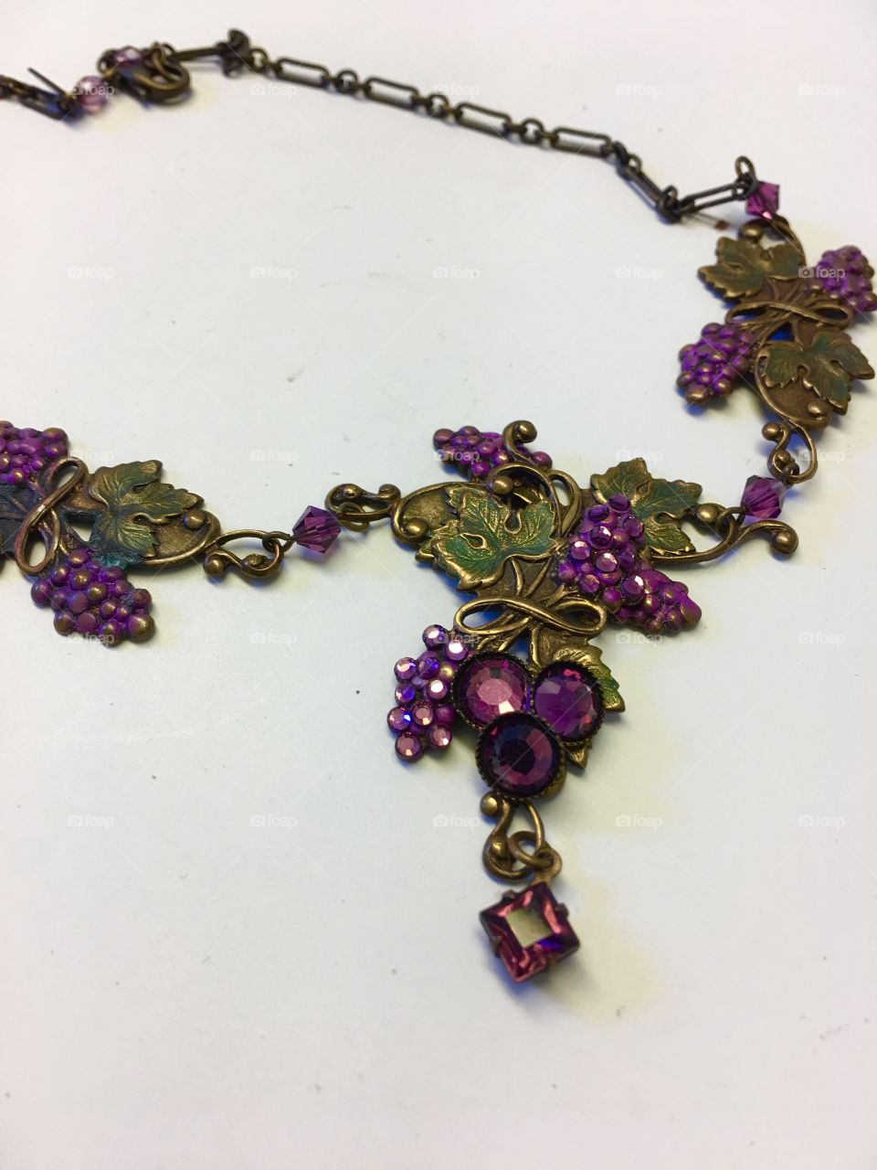 Precious gift  from my husband. Purple grape clusters  made from  jewels with bronze colored leaves on a lovely necklace with an antique appearance. 