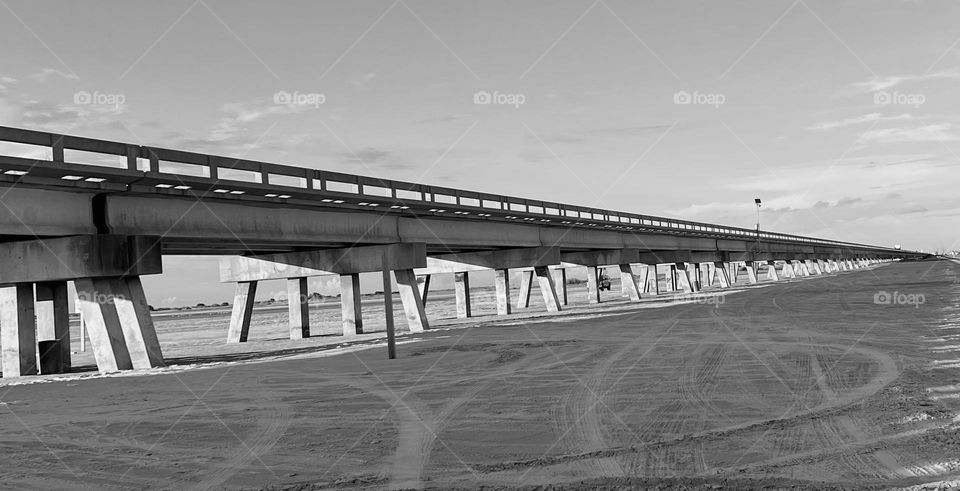 Editors choice. B&W of the long, empty San Luis Pass bridge in Texas going from the beach 🤍