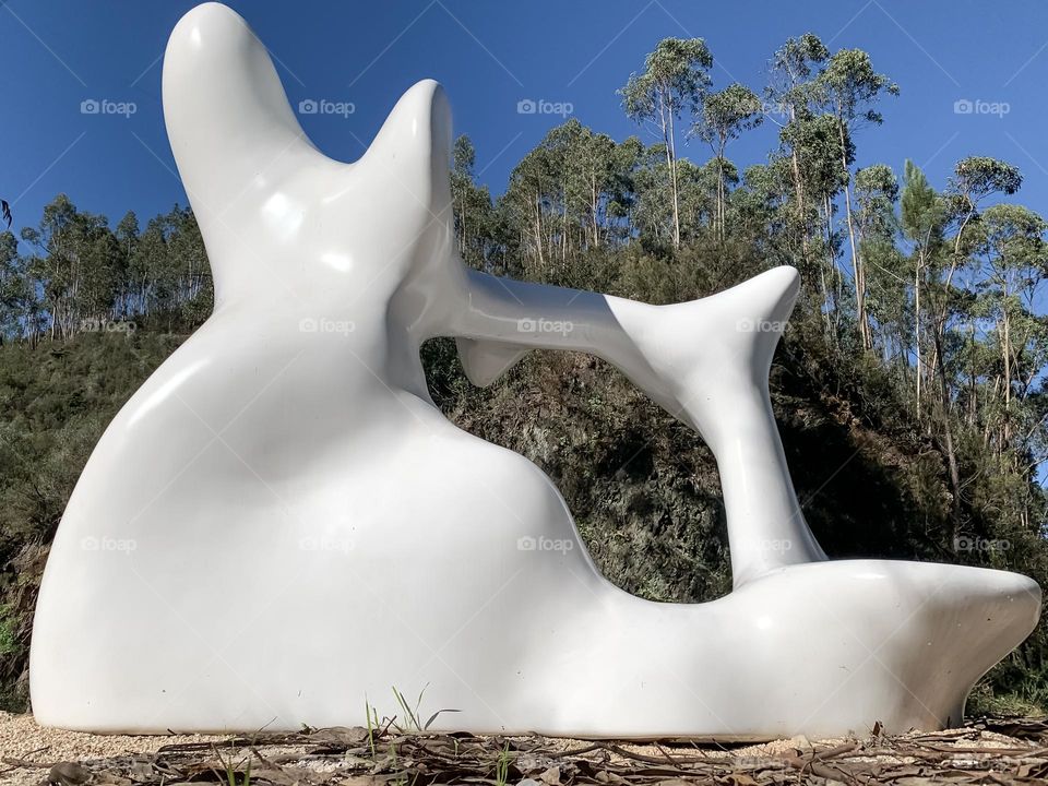 A white sculpture “Ex-Humus II” (2022) by Portuguese artist Tiago Francez, found on a countryside path in Central Portugal 