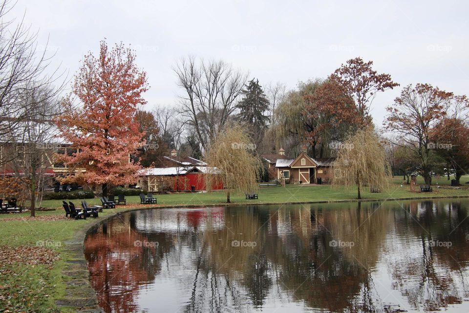 Reflection of red barn in pond in autumn