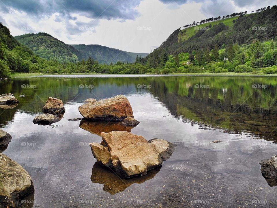 Clouds and mountain reflecting on lake