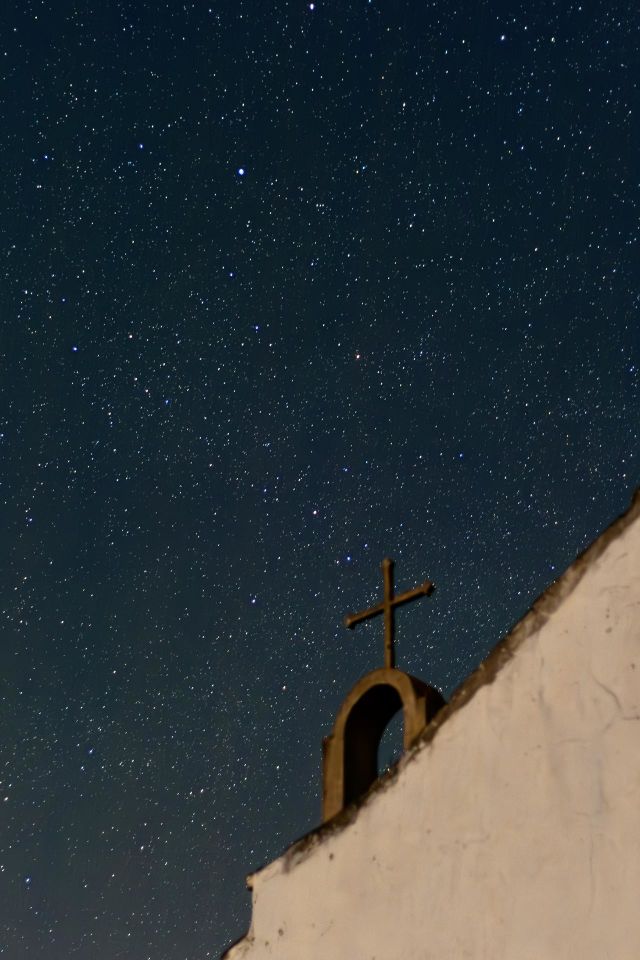 An old disused church shares the night sky with hundreds of stars
