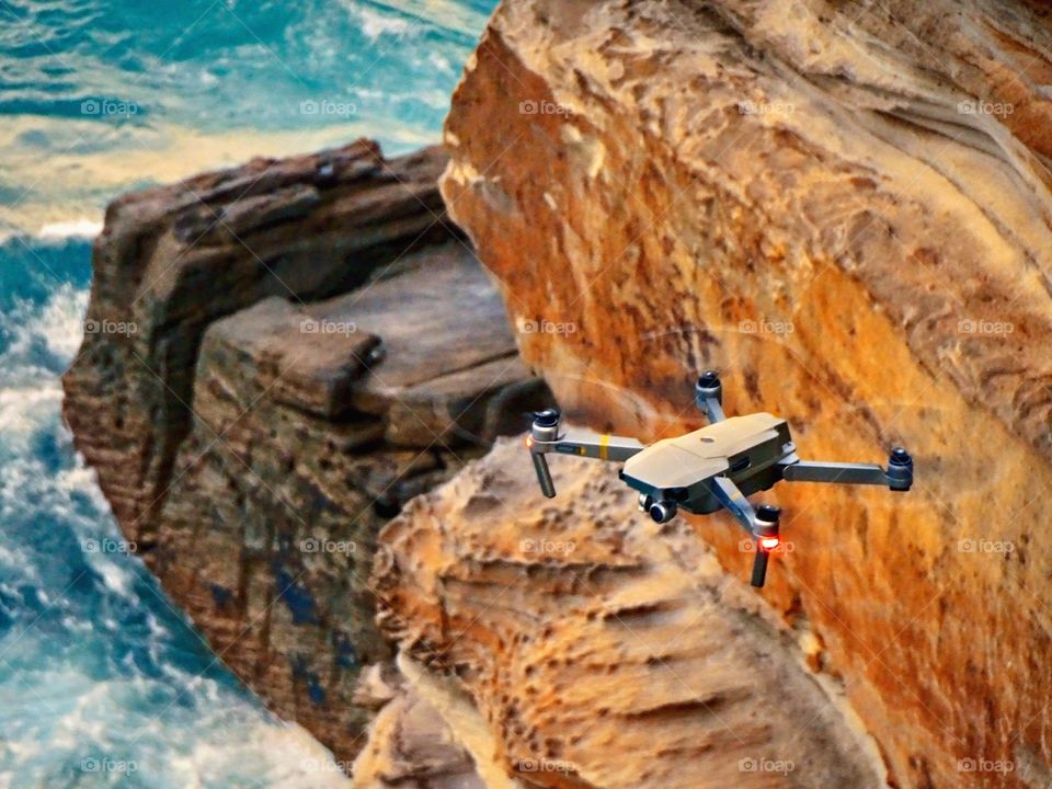 Drone flying high above sea and cliffs, taking photos from above. Beautiful colors of nature. 