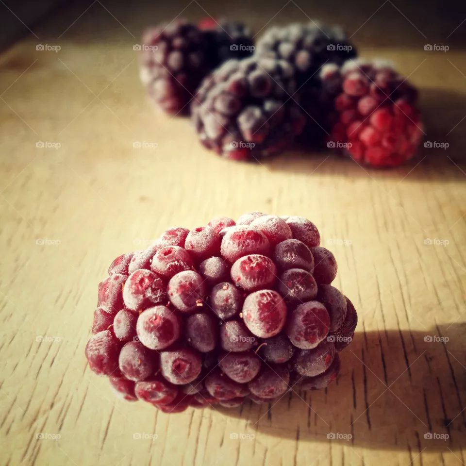 Lone blackberry. Blackberries on a chopping board