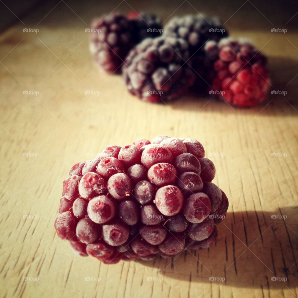 Lone blackberry. Blackberries on a chopping board