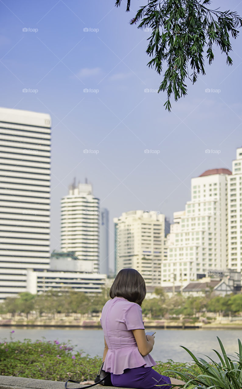 Portrait of Asean Women with short hair brown Background Building blurry.