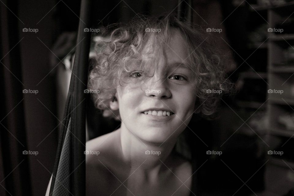 portrait of a young man with curly hair black and white photo