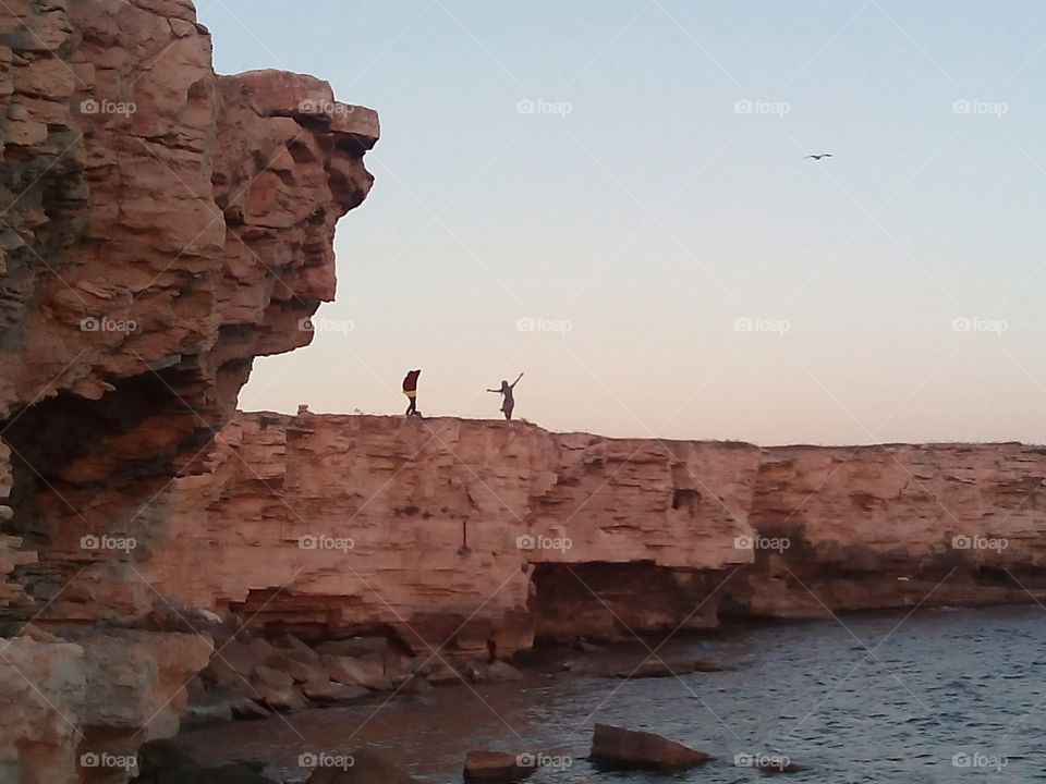 peoples on a sea rocks