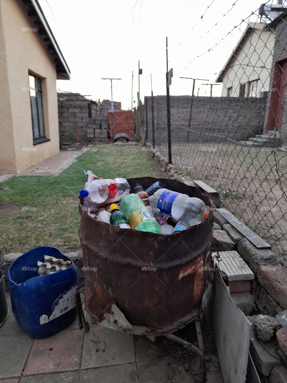 A photo of a recycling bin/trash can. Plastic bottles