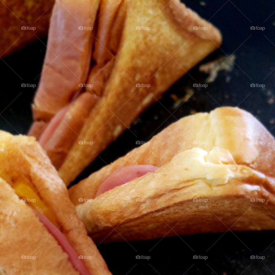 Closeup texture of a hot delicious toasted ham and cheese sandwich