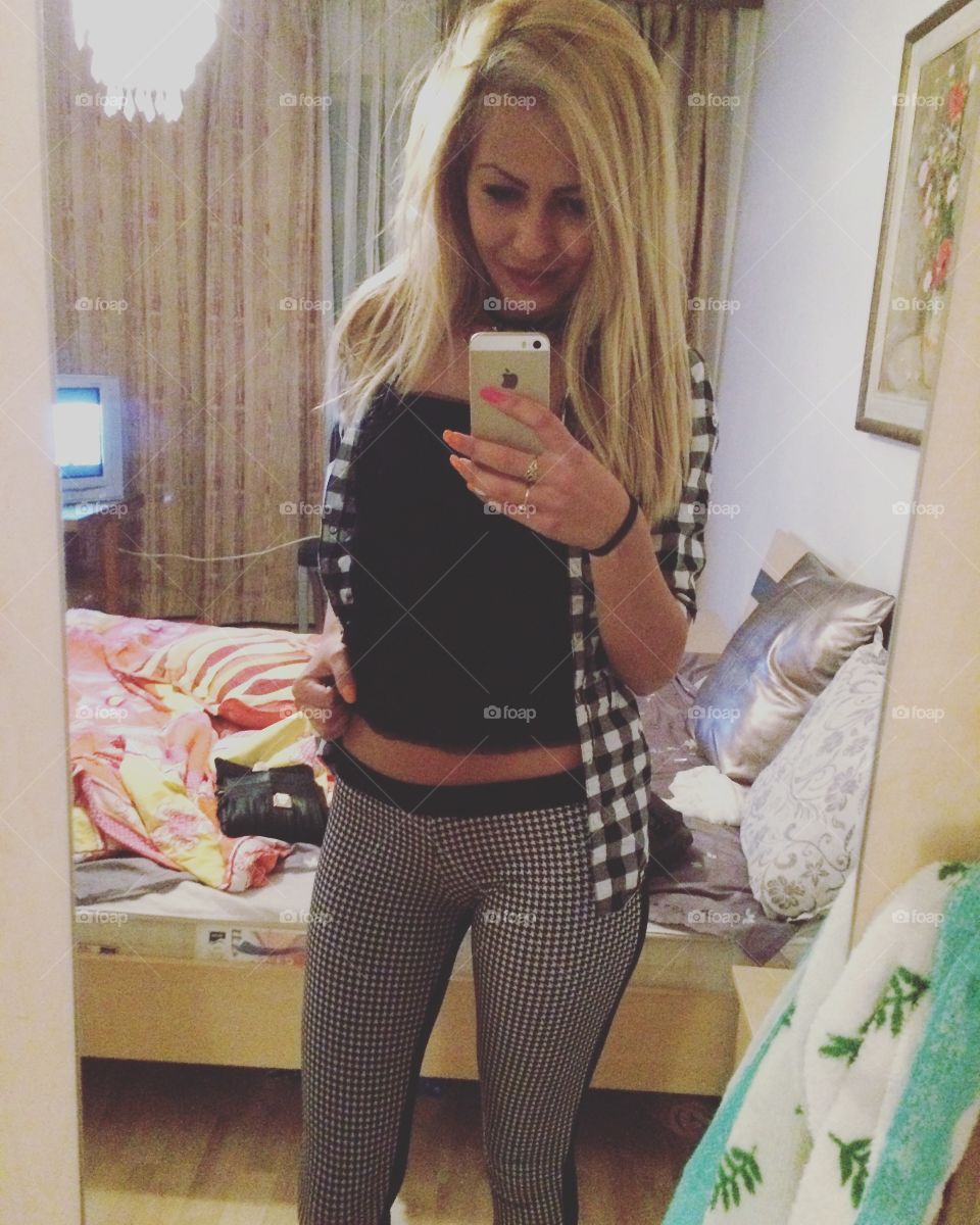 Reflection of a woman taking selfie