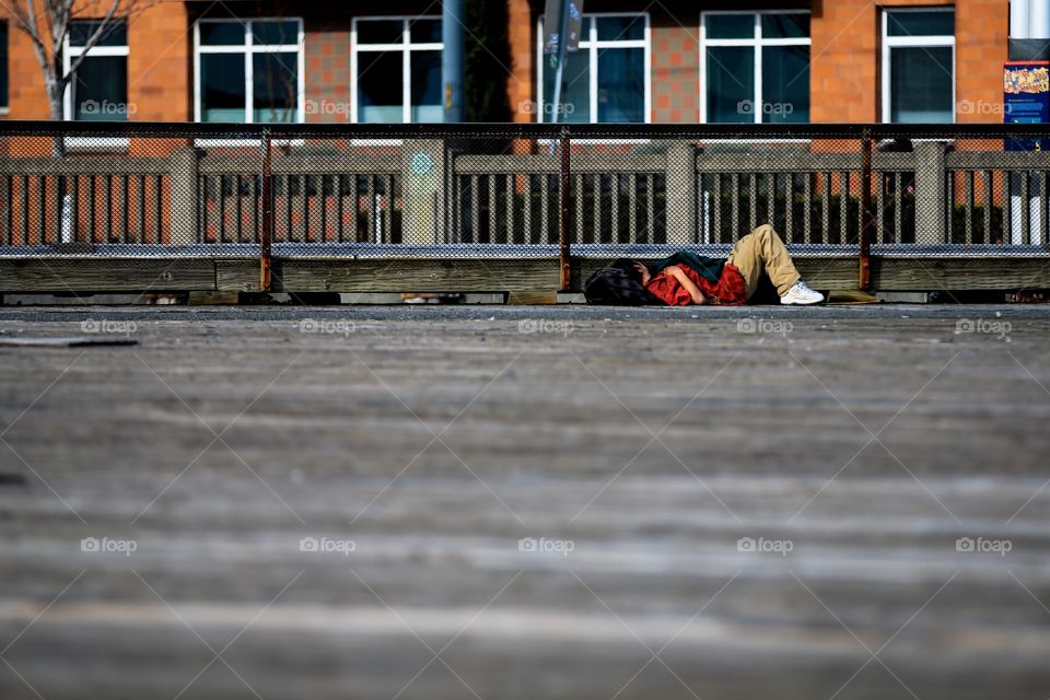 Homeless man sleeping in the road